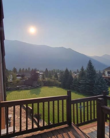 Wooden deck with mountain and valley views at dusk, Columbia Falls, Montana